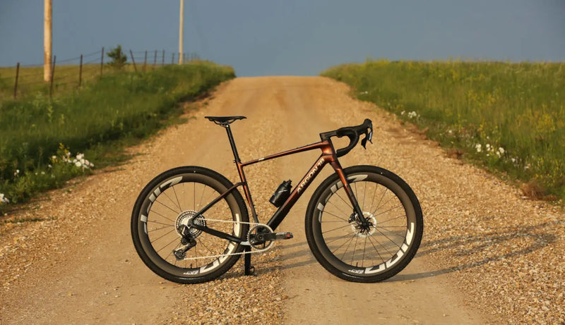 Bicycle on a dirt road with grass and clear sky