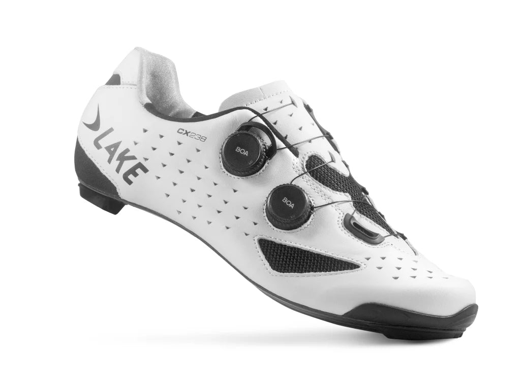 White cycling shoe with black accents on a white background