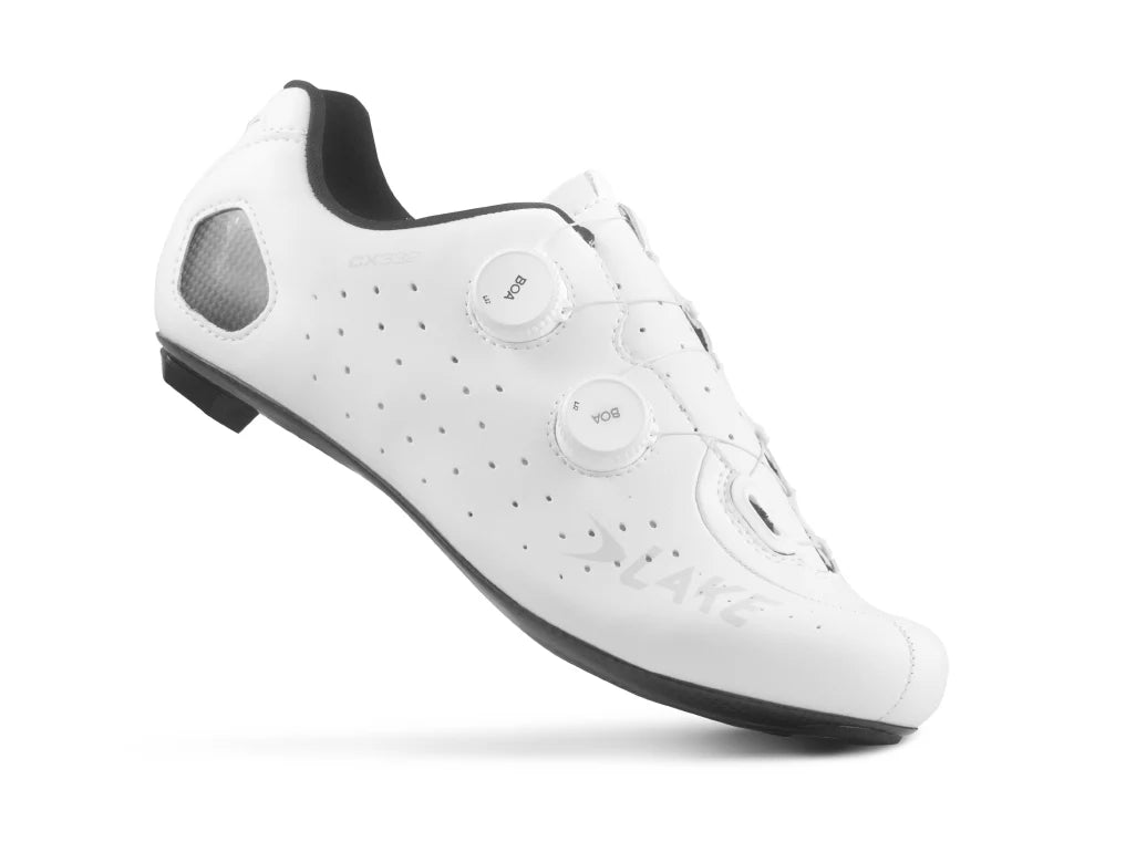 White cycling shoe with black soles on a white background