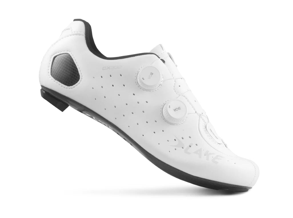 White cycling shoe with black soles on a white background