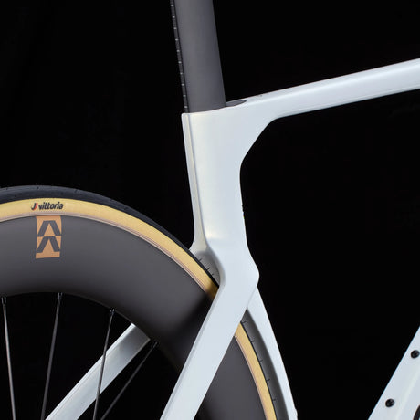 Close-up of white Cervélo S5 Dura-Ace Di2 Road Bike seat stay and rear wheel junction, showcasing aerodynamic frame design and Vittoria tire setup.