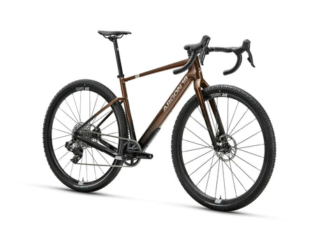 Argon 18 Dark Matter Rival XPLR AXS Gravel Bike in bronze with drop handlebars and DT Swiss wheels, ideal for rugged terrain cycling.