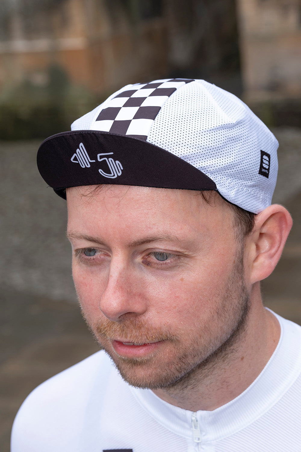 Side view of 45th Anniversary Mesh Cycling Cap featuring lightweight mesh fabric and commemorative graphics, perfect for cycling enthusiasts.
