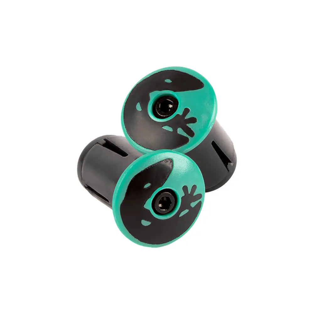 The black handlebar end plugs, featuring a green outer rim and stylized alien face design, are crafted to complement the Lizard Skins DSP V2 2.5mm Bar Tape. The design includes a striking black circular cutout for the alien's eye in the center.
