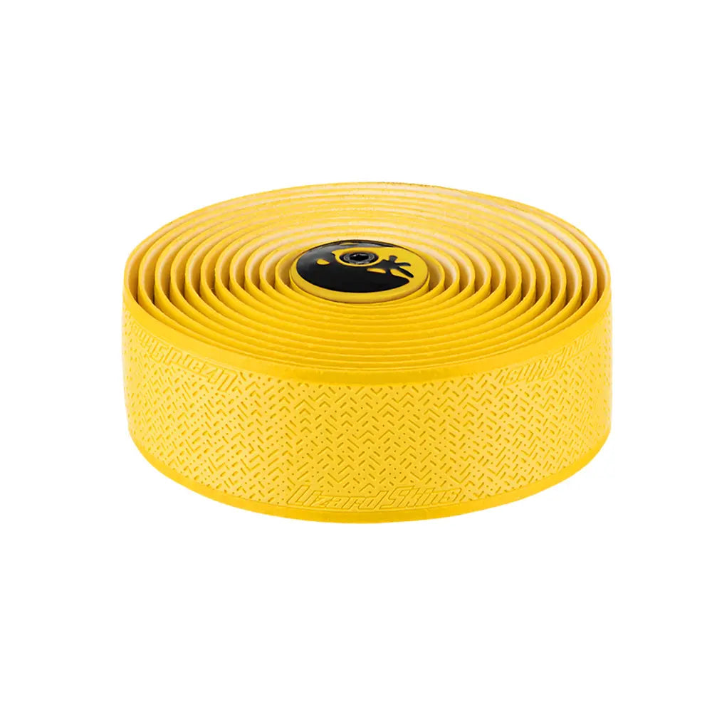 The Lizard Skins DSP V2 2.5mm Bar Tape is a rolled yellow bicycle tape with a textured pattern to improve grip. It boasts a durable design and features the Lizard Skins logo on the central circular end cap with black detailing.