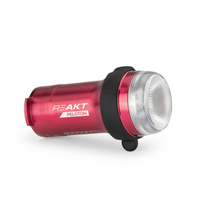Red bike light with 'REAKT' and 'Peloton' branding on a white background