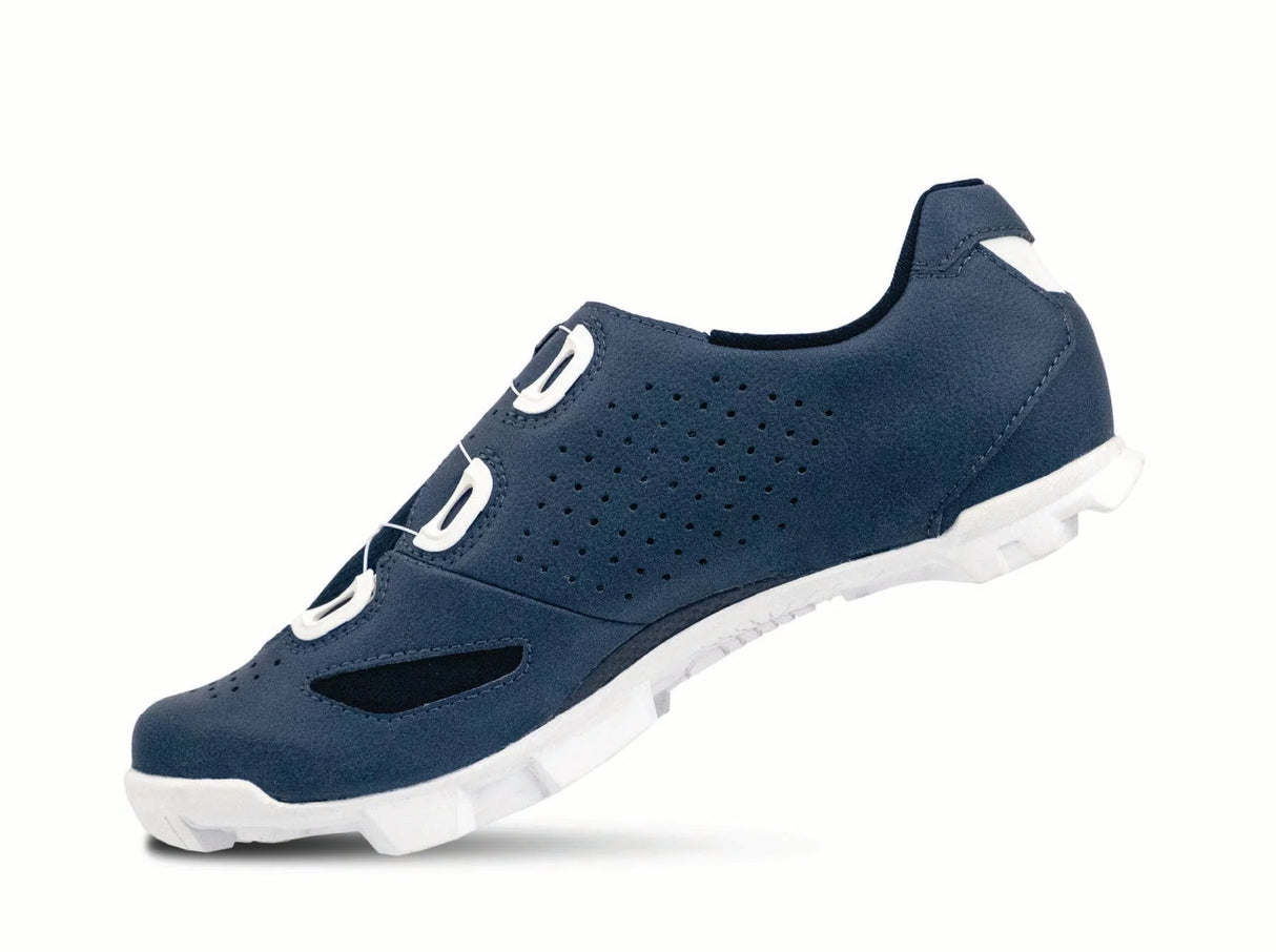 Navy blue athletic shoe with white sole on a white background