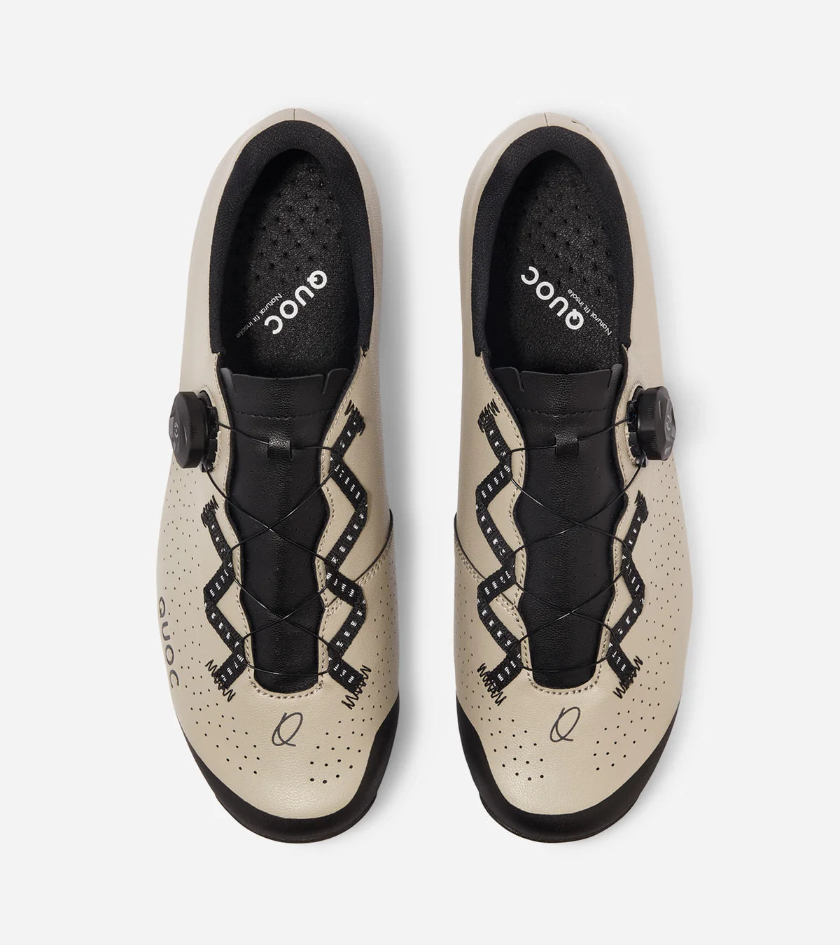 Top view of QUOC Escape Off-Road Shoe in sand color, featuring zigzag lacing and perforated design for airflow and fit.