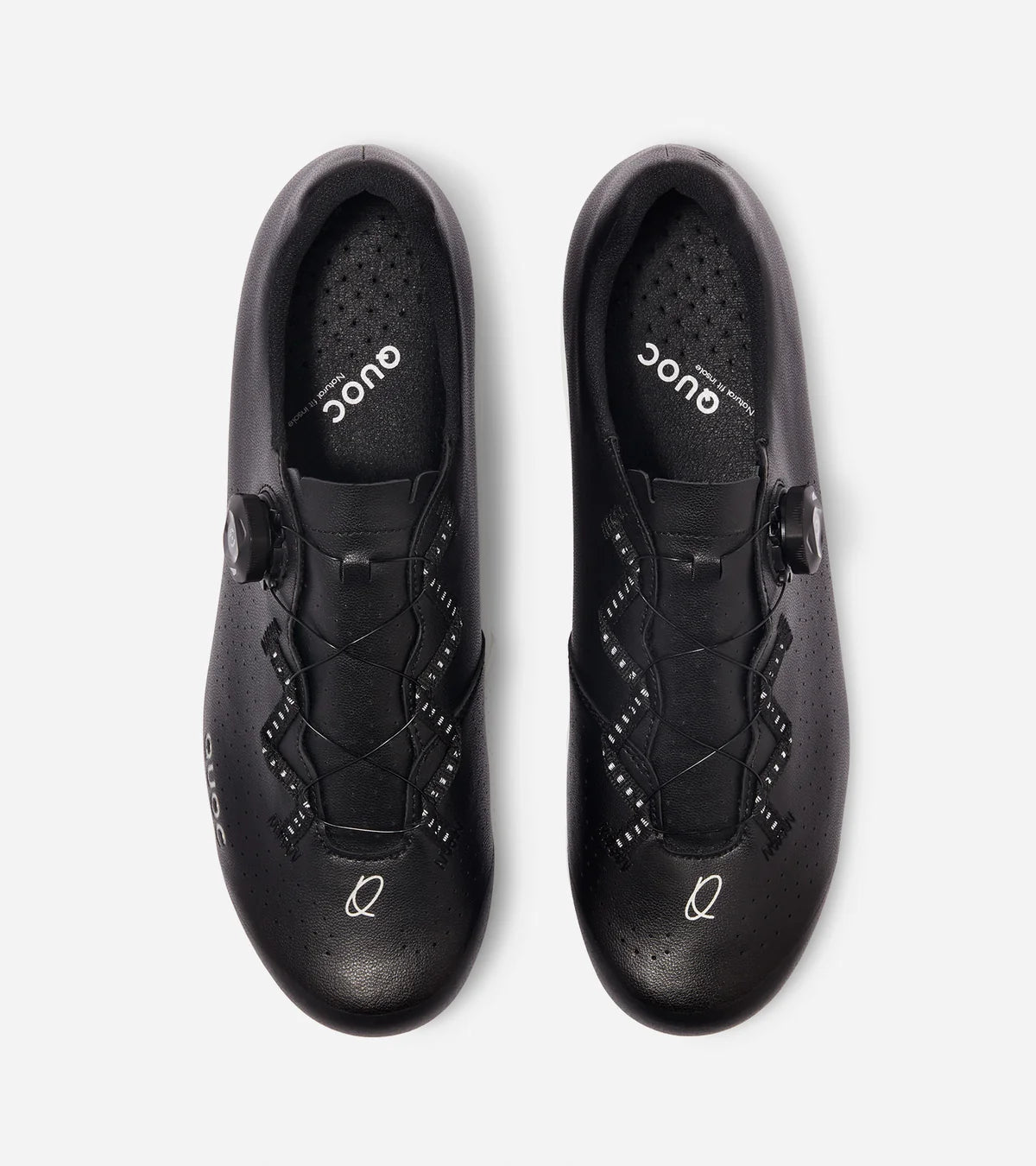 Top view of black QUOC Escape Road Shoes featuring perforated upper and ergonomic lace system for breathability and secure fit.