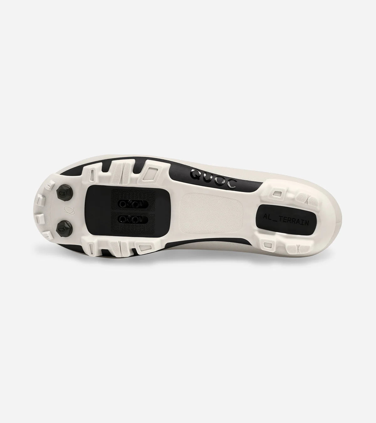 Outsole of QUOC Gran Tourer XC Off-Road Shoe in white, showing aggressive tread pattern and SPD cleat compatibility for off-road grip.