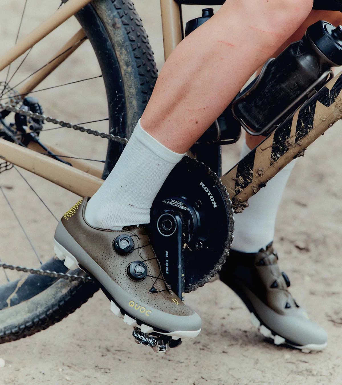 Close-up of QUOC Gran Tourer XC Off-Road Shoes in brown during a gravel ride, highlighting their rugged design and pedal efficiency.