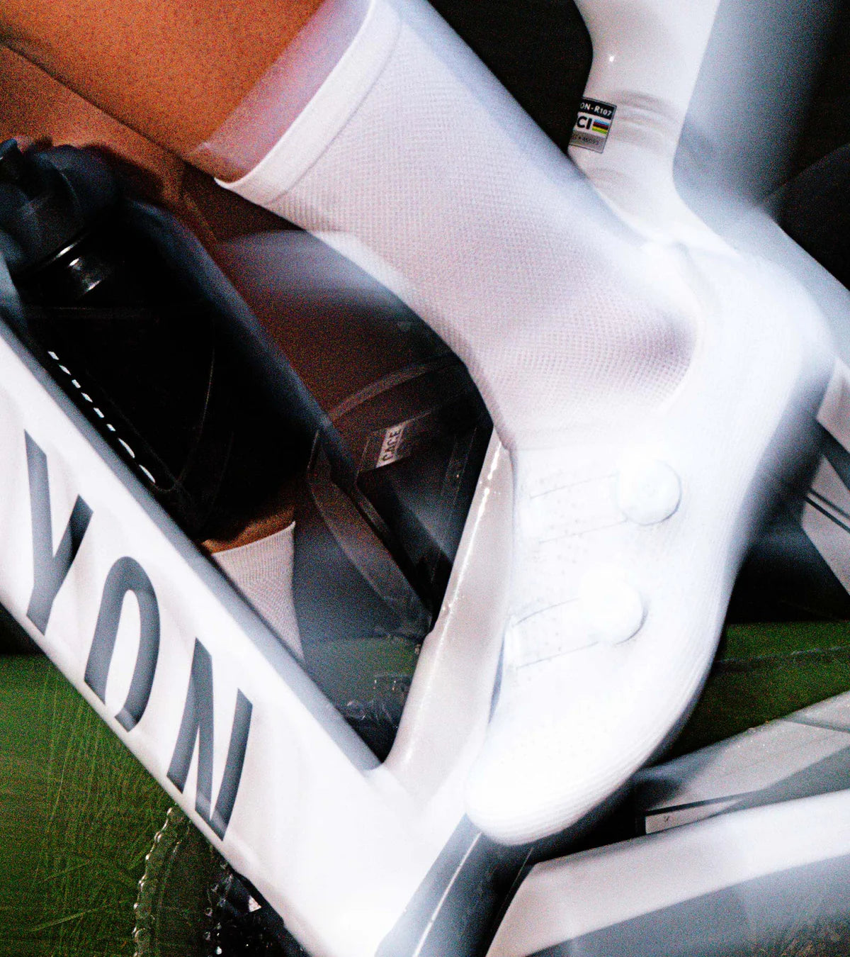 Cyclist wearing QUOC M3 Pro Road Shoes while pedaling, highlighting the shoe's secure fit and performance on a road bike.