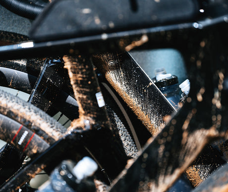 Detail shot of muddy Cervelo Aspero-5 SRAM Force AXS 1 Gravel Bike frame and drivetrain, showing durability in rough terrain.
