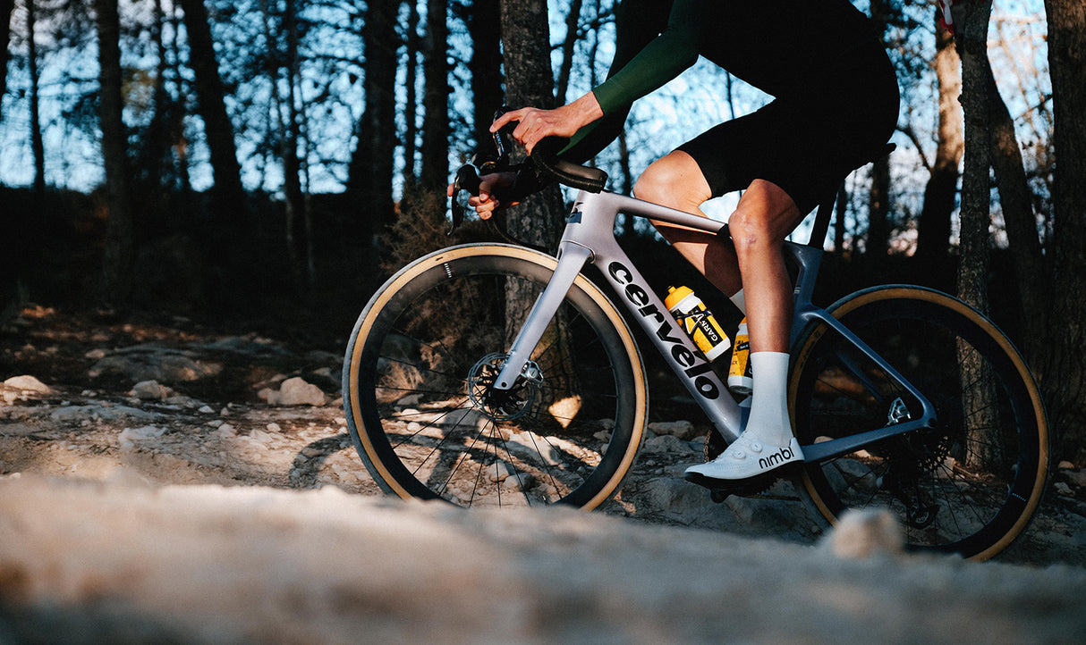 Cyclist riding Cervelo Aspero-5 SRAM Force AXS 1 Gravel Bike on rocky trail, showcasing real-world gravel performance.