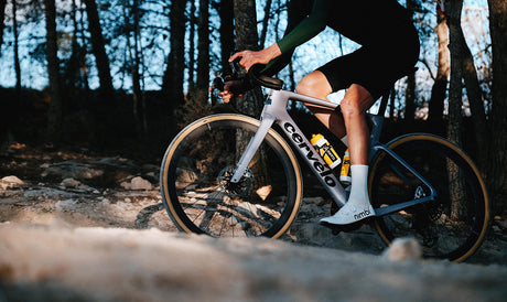Cyclist riding Cervelo Aspero-5 SRAM Force AXS 1 Gravel Bike on rocky trail, showcasing real-world gravel performance.
