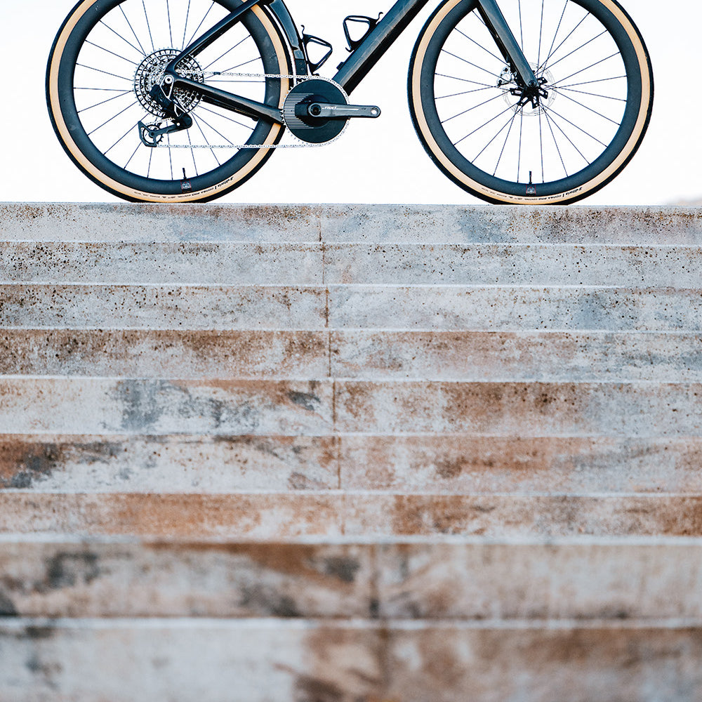 Cervelo Aspero-5 SRAM Force AXS 1 Gravel Bike on stone steps, highlighting its lightweight frame and aggressive geometry.