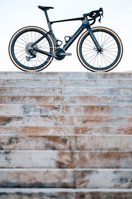 Cervelo Aspero-5 SRAM Force AXS 1 Gravel Bike on stone steps, highlighting its lightweight frame and aggressive geometry.