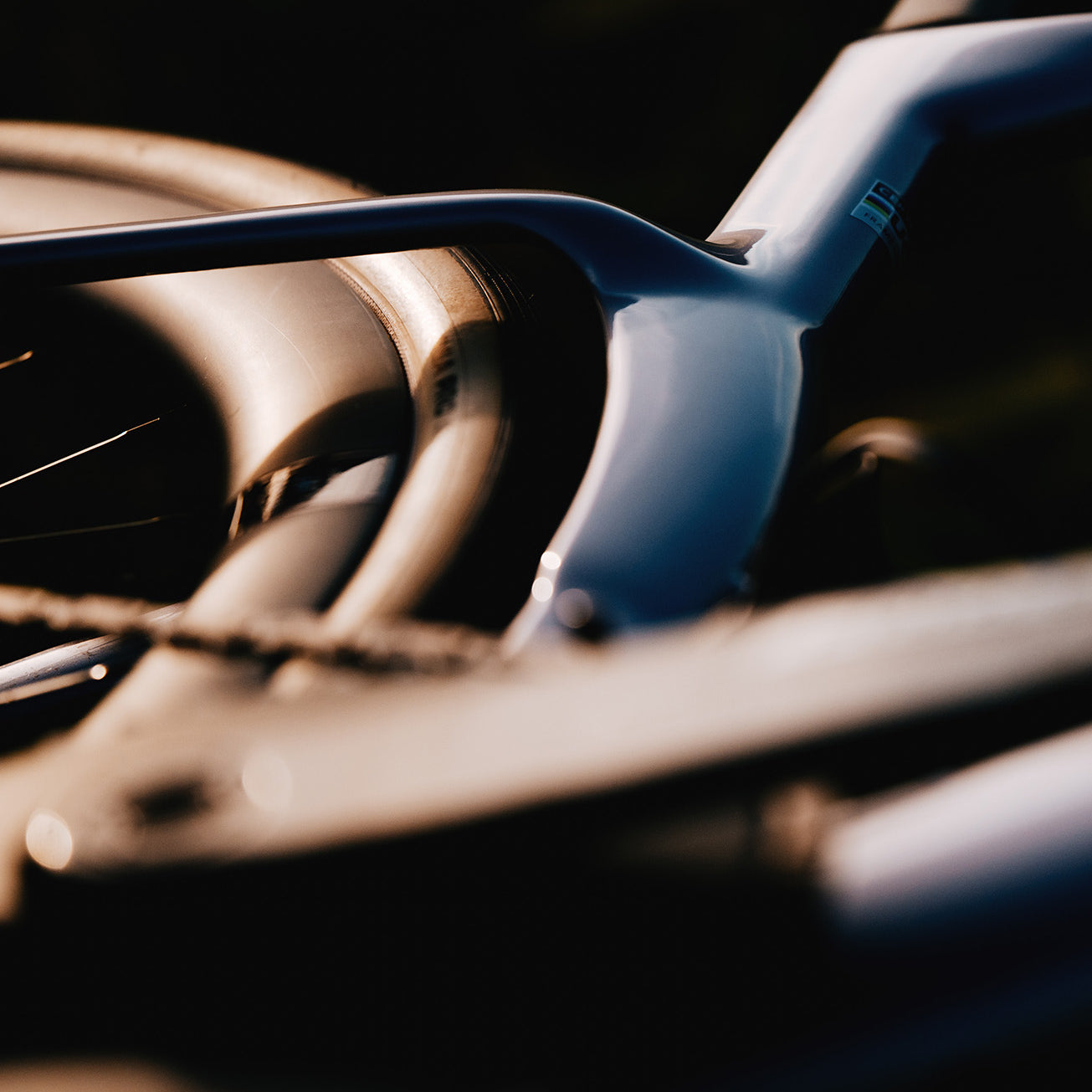 Artistic detail of Cervelo Aspero-5 SRAM Force AXS 1 Gravel Bike's rear triangle and wheel, emphasizing frame aerodynamics.