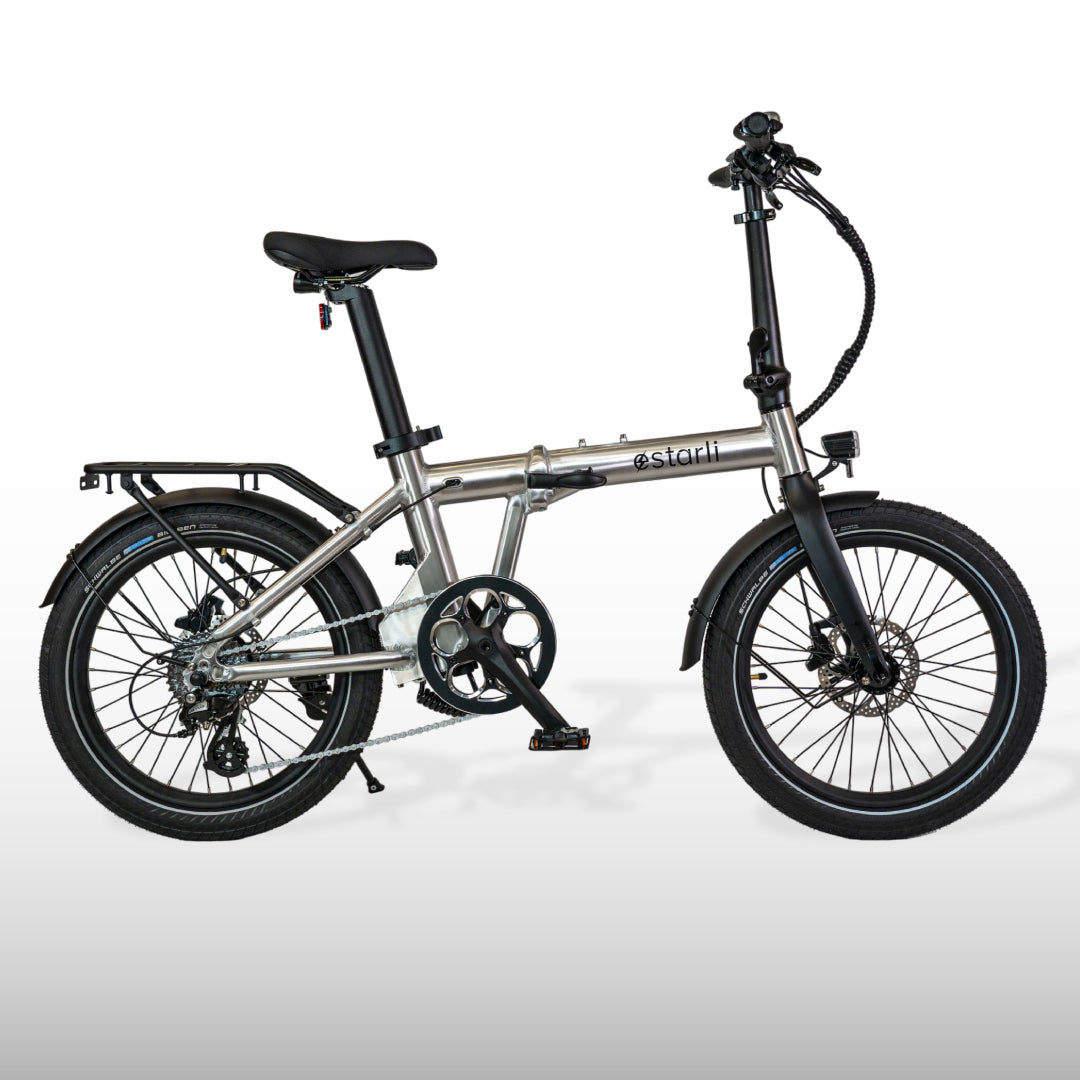 Silver estarli E20.8 Play Hybrid E-Bike featuring a foldable frame and rear rack, perfect for commuting and compact storage.