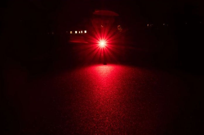 Red light source in a dark setting