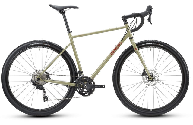 2025 Genesis Croix De Fer 30 Gravel Bike in side profile showcasing its rugged steel frame and wide all-terrain tires for adventure cycling.