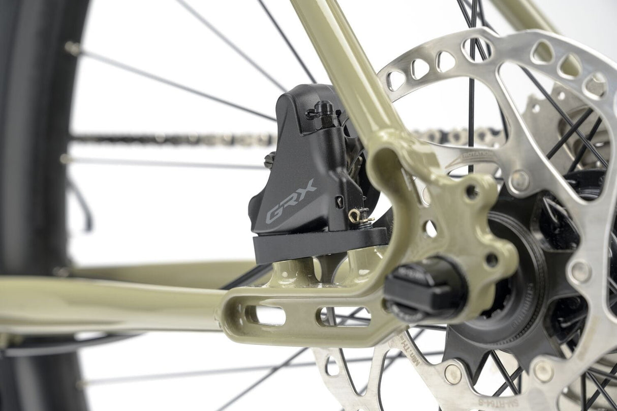Close-up of Shimano GRX disc brake caliper on the 2025 Genesis Croix De Fer 30 Gravel Bike for powerful and consistent braking.