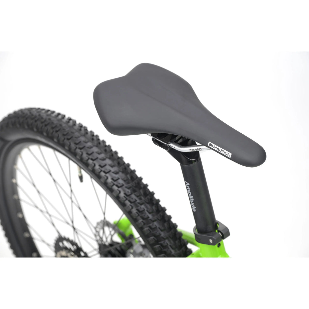 Black padded bike saddle on bright green frame with knobby tire and 24-inch wheel.