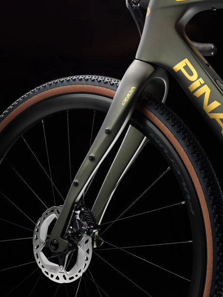 Close-up of a bicycle wheel with 'Pinarello' branding on a black background