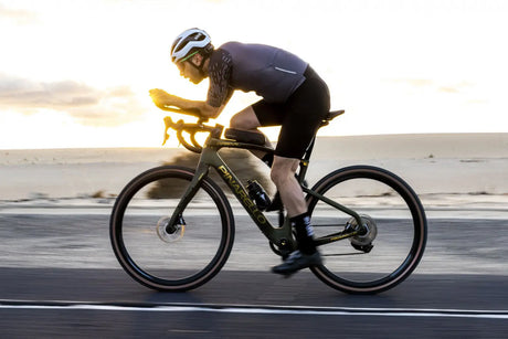 Cyclist on a road bike during sunset