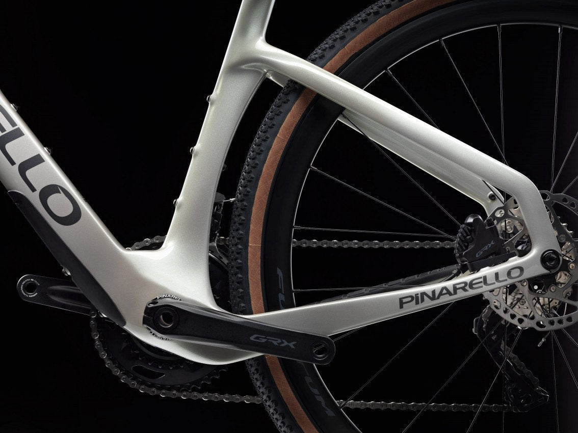 Pinarello bicycle frame with chain and gear on a black background