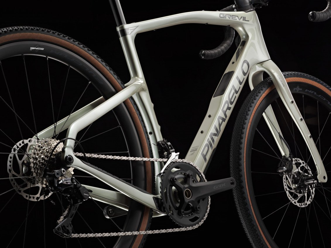 White bicycle with 'Pinarello' branding on a black background