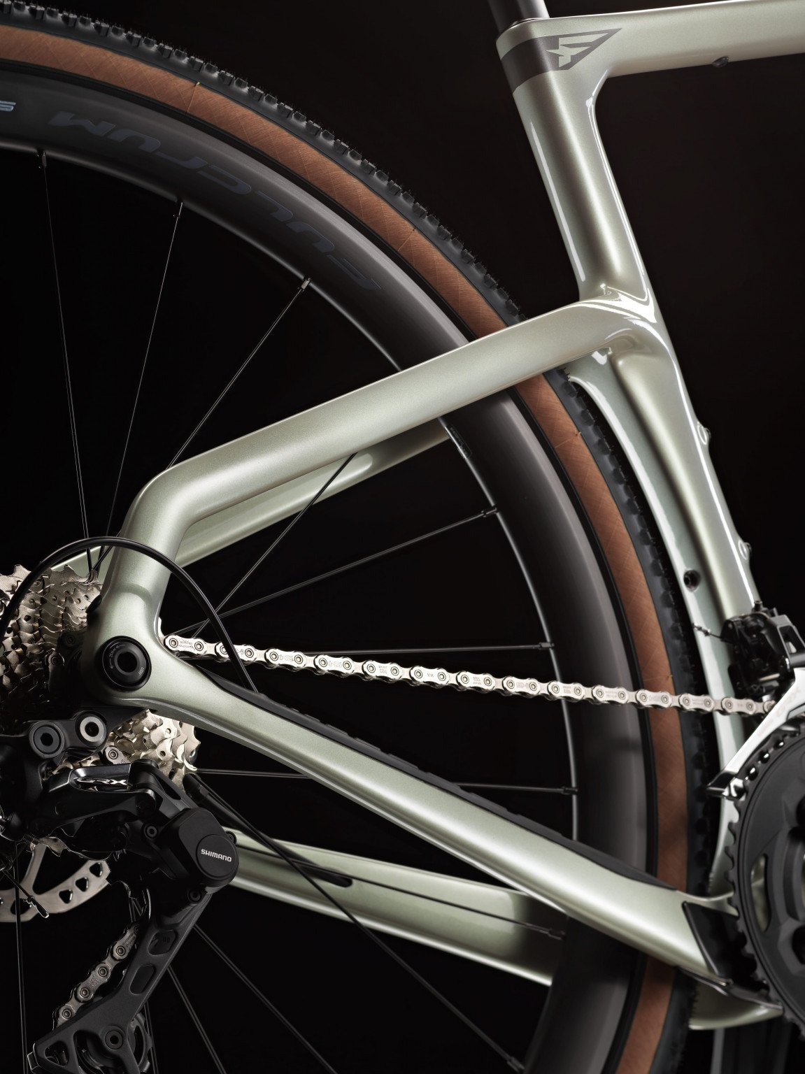 Close-up of a bicycle frame and wheel on a black background