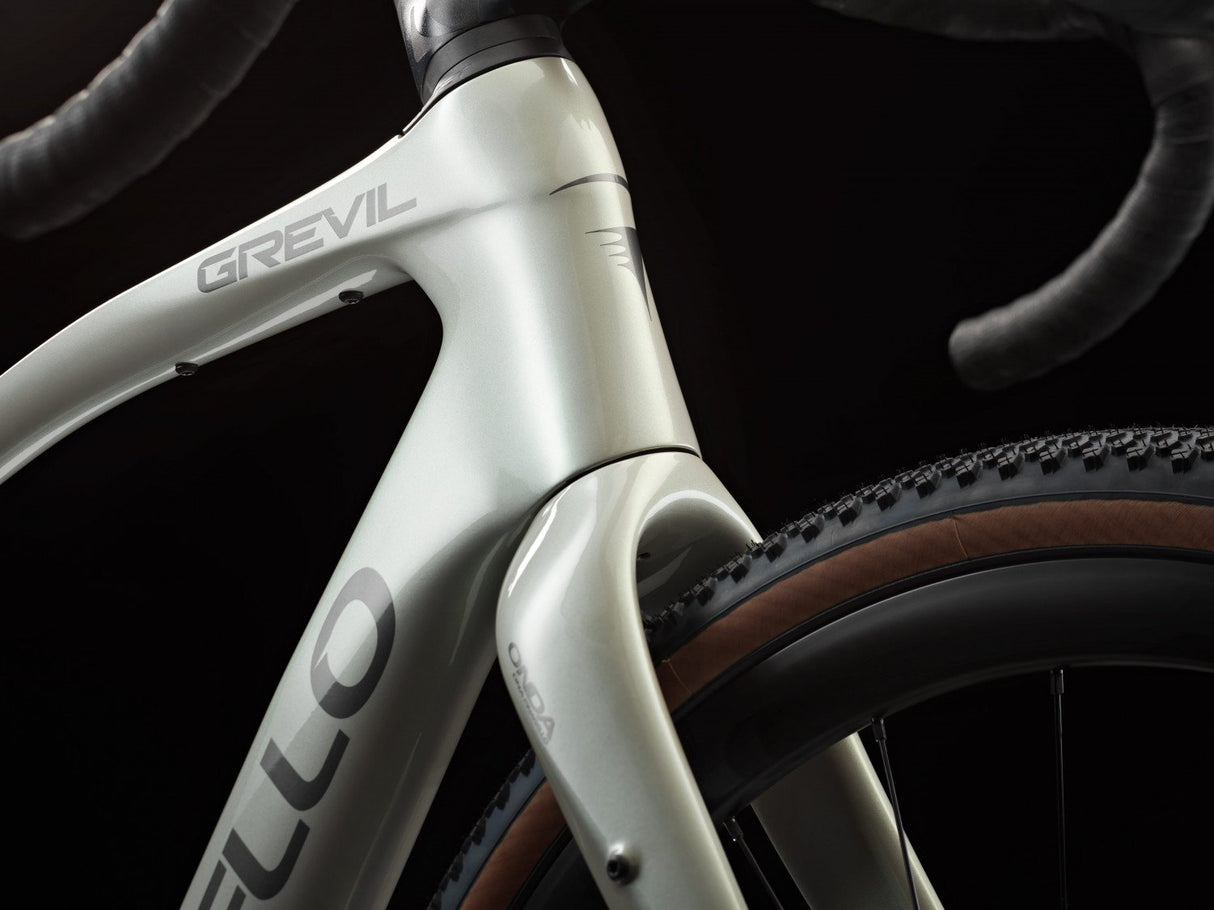 Close-up of a bicycle frame with 'Grevil' branding on a dark background