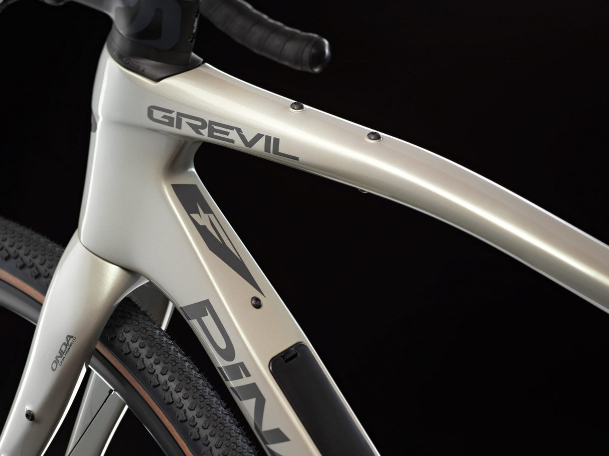 Close-up of a bicycle frame with 'Grevil' branding on a black background