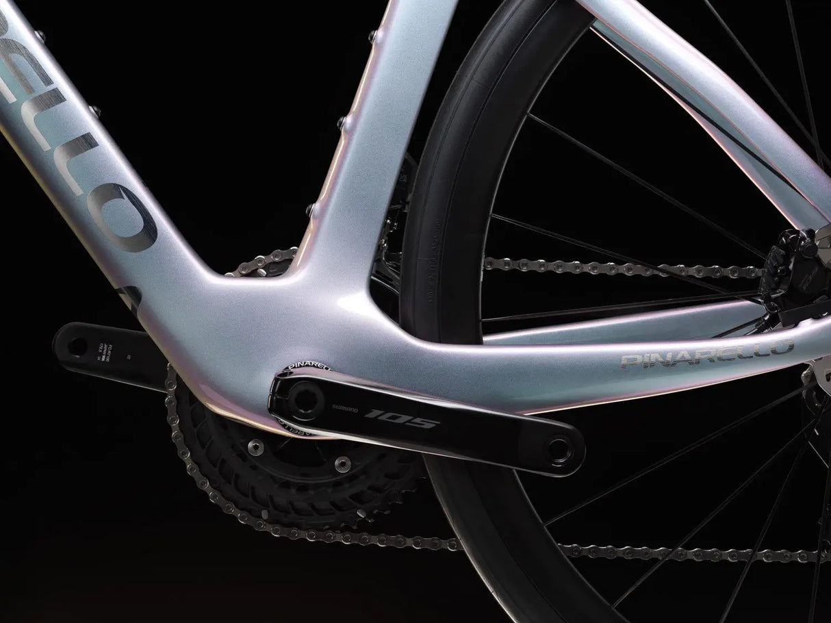 Close-up of a bicycle frame with chain and wheel on a black background