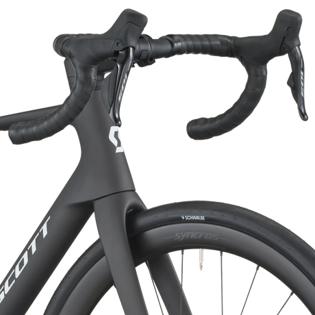 Close-up of a black bicycle handlebar with Scott branding on a white background
