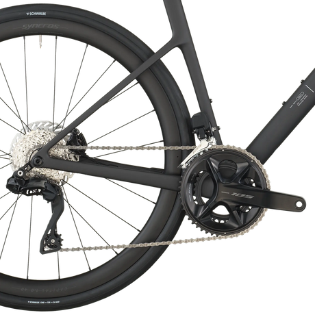 Close-up of a bicycle's rear wheel and gear system on a white background