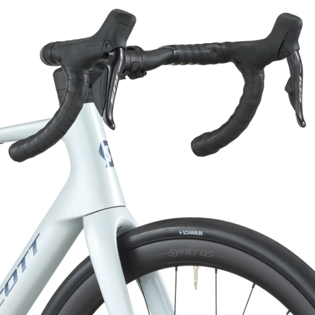 Close-up of a bicycle handlebar with black grips and white frame on a white background