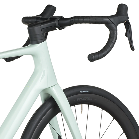 Light blue bicycle with black handlebars and tires on a white background