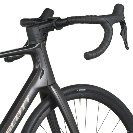 Close-up of a black bicycle with handlebars and front wheel on a white background