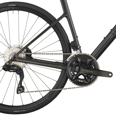 Close-up of a bicycle's rear wheel and gear system on a white background