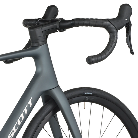 Close-up of a gray bicycle with handlebars and front wheel on a white background