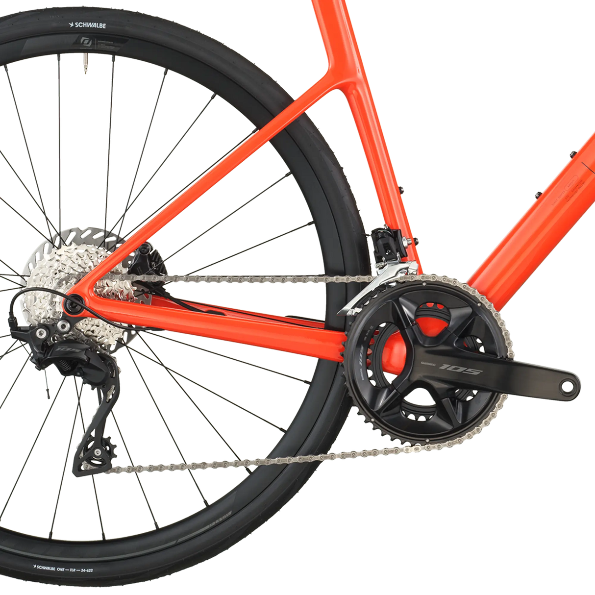 Close-up of a red bicycle with chain and gear system on a white background