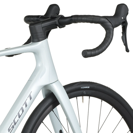 Close-up of a bicycle with a white frame and black components on a white background