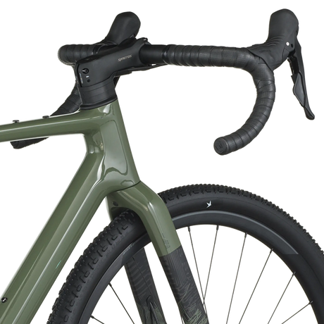 Close-up of a green bicycle with black handlebars on a white background