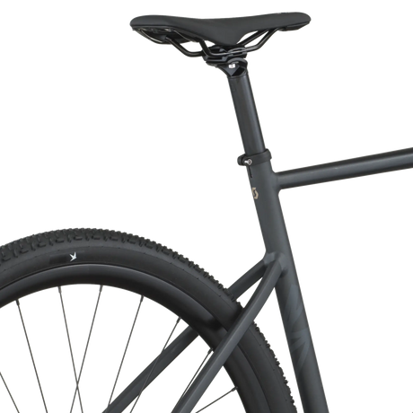 Close-up of a black bicycle frame and wheel on a white background