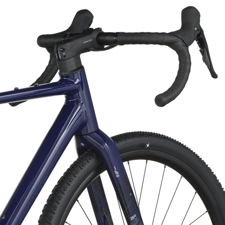 Close-up of a blue bicycle with black handlebars on a white background