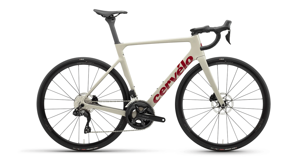 Cervelo Soloist 105 Di2 Road Bike in sand color with red logo, featuring Shimano Di2 shifting and disc brakes for high-speed road cycling performance.