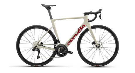 Cervelo Soloist 105 Di2 Road Bike in sand color with red logo, featuring Shimano Di2 shifting and disc brakes for high-speed road cycling performance.