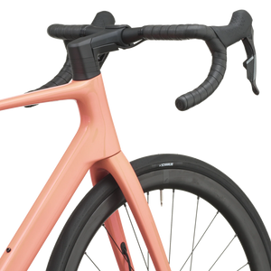 Peach pink Scott Addict 25 road bike from a front three-quarter angle with the SCOTT logo on the down tube.